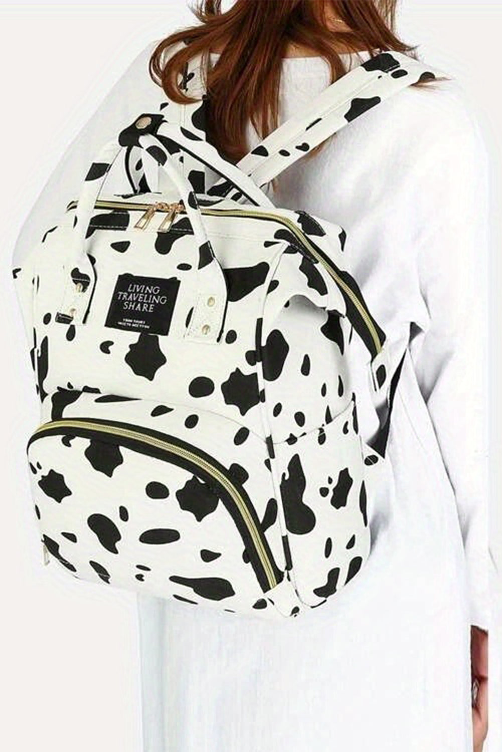 Mochila de lona con múltiples bolsillos y estampado de lunares de vaca en blanco brillante