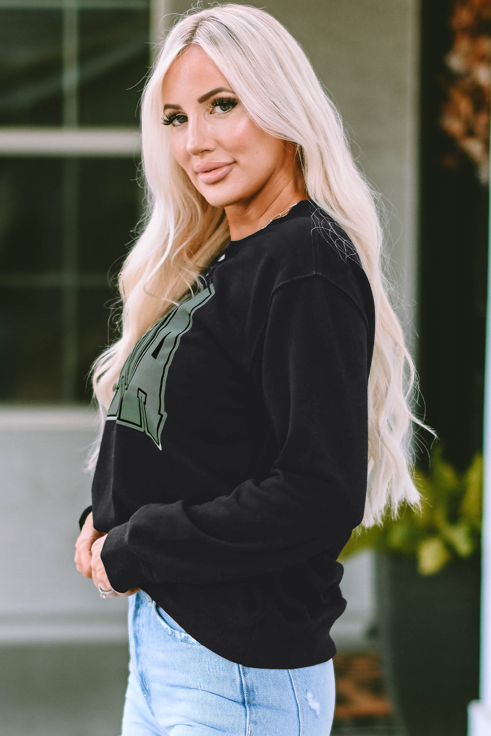 This MAMA graphic pullover sweatshirt is a perfect blend of classic and fashionable. Its loose-fitting drop-shoulder style is perfect for layering over jeans and joggers. Crafted from a cozy blend of 65% Polyester and 35% Cotton, it comes in classic black and is exclusively available from Moodz Boutique.