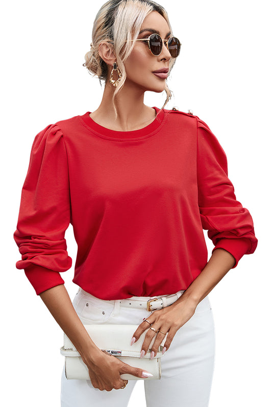 Blusa de manga larga con detalle de botón rojo