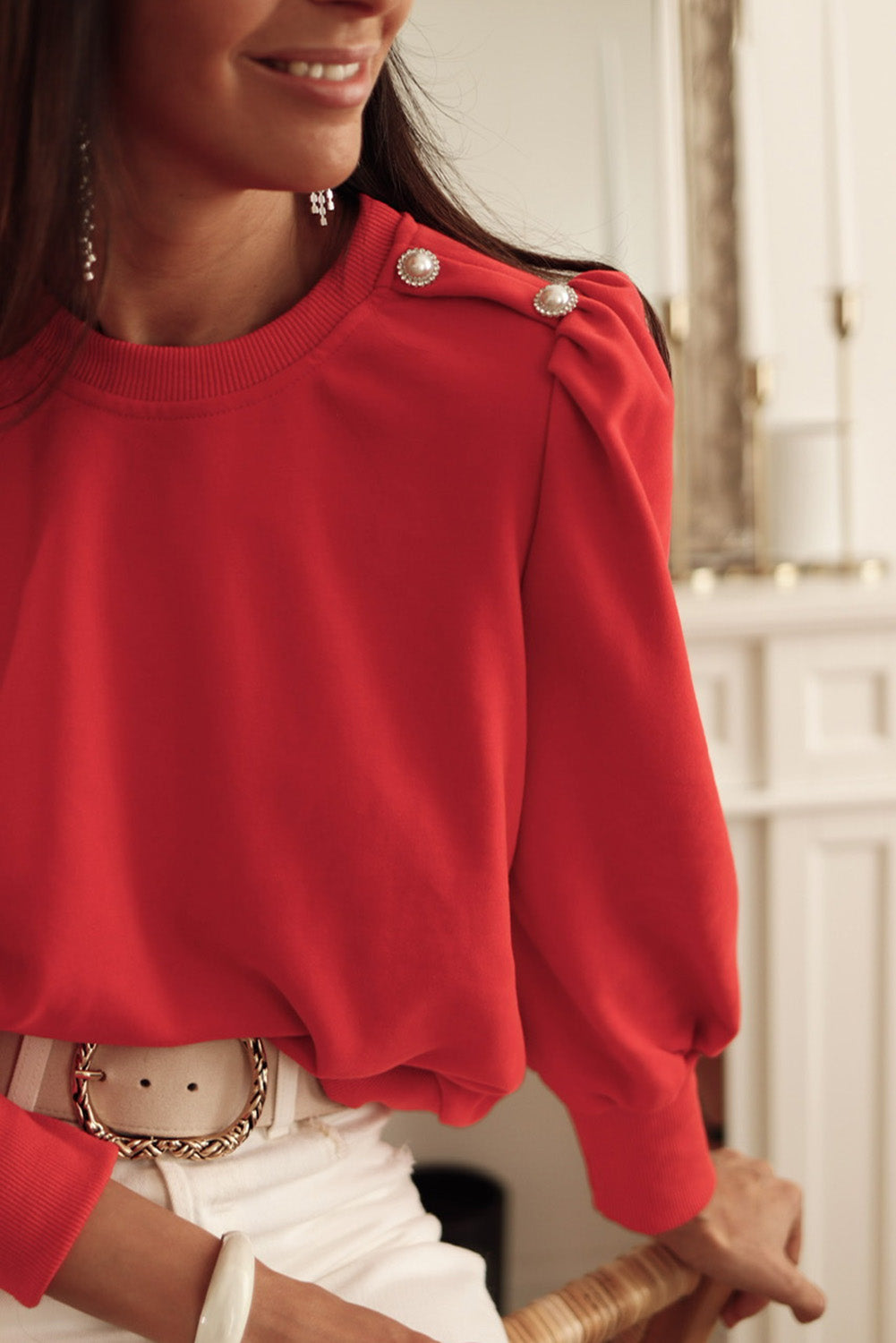 Blusa de manga larga con detalle de botón rojo