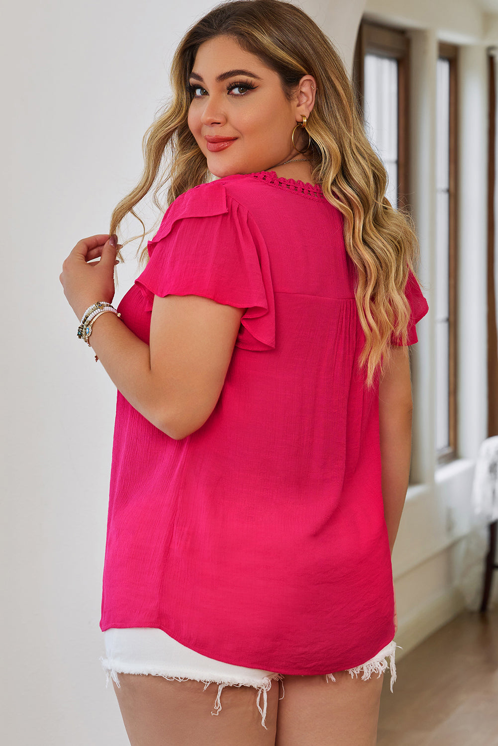 This Curvy blouse has it all—from lightweight material and crochet details to a v-neck and flutter sleeves. The relaxed fit flatters most shapes and looks great with pants or skirts! 55% Viscose, 45% Polyester. Pick it up in Black or Rose.