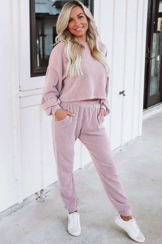 Unlock chic comfort with this Apricot Powder Ribbed Pullover and Jogger Lounge Set! This set includes a textured pullover with a cropped-length, plus high-waisted joggers with side pockets. Enjoy the cozy feel of 75% Polyester, 20% Viscose, and 5% Elastane!