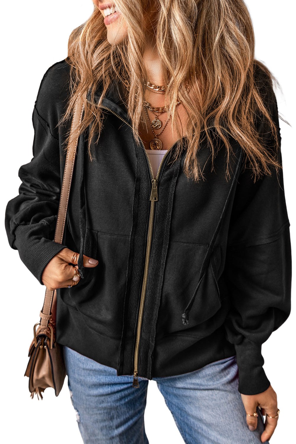 Cozy up in this relaxed and casual hoodie with a full zipper and unique exposed seam design. Crafted from 65% Polyester and 35% Cotton, it's available in a stylish black from Moodz Boutique!