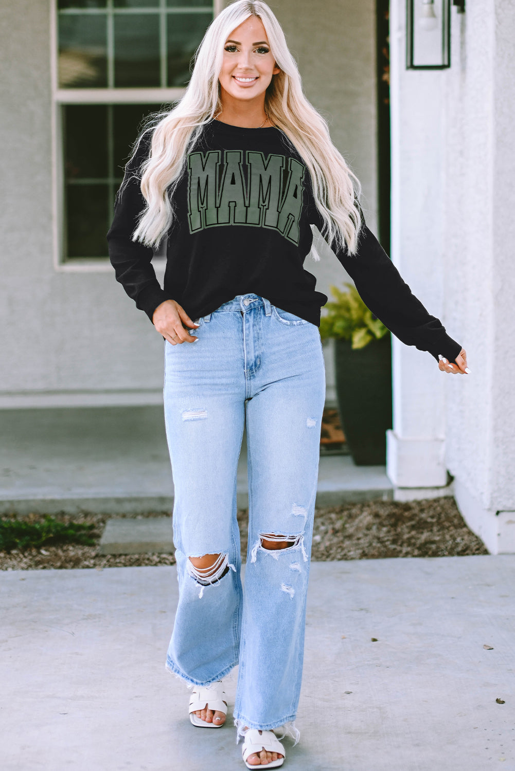 This MAMA graphic pullover sweatshirt is a perfect blend of classic and fashionable. Its loose-fitting drop-shoulder style is perfect for layering over jeans and joggers. Crafted from a cozy blend of 65% Polyester and 35% Cotton, it comes in classic black and is exclusively available from Moodz Boutique.