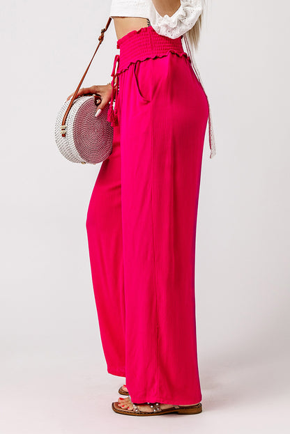 These pants will keep you lookin' sassy and comfy! The smocked waist brings the unique, and they slip on with ease. The wide legs flatter your pins, while the lightweight, 100% viscose fabric's as breezy as it is chic. Rose color--so you can bloom!