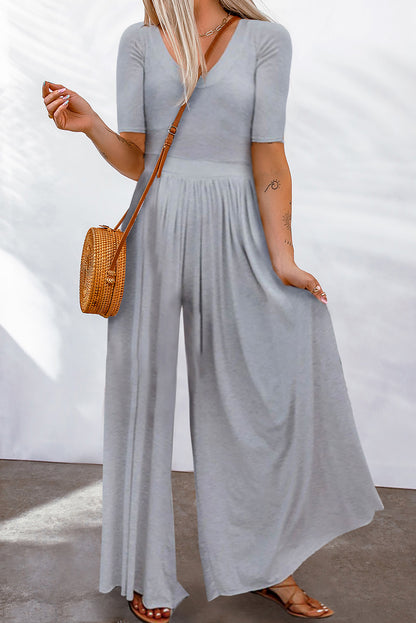 Make a chic statement in this sassy short-sleeved jumpsuit! It flatters your figure with a bodice fit and flare, a cinched waist, and a flowy wide-leg design. This comfy 'n' airy fabric is great for chill days, spruced-up events, and everything in between. 85% Polyester, 15% Elastane – choose from Pink, Light Gray, Black, Red, Gray, or Leopard.