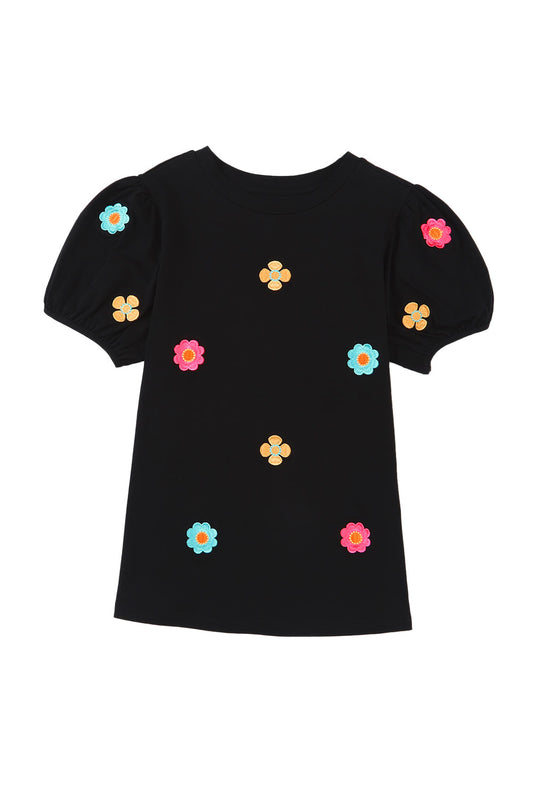 Blusa con mangas abullonadas y bordado floral negro