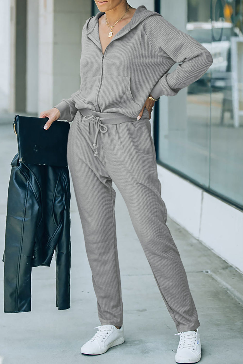 This FIERCE activewear set (holla!) consists of a hoodie and pants, with waffle-fabulous fabric and a zipper/drawstring combo that makes slipping it on or off NBD. Whether you're shopping, stomping up a hill, or scoring a goal, this 'fit pairs perfectly with a pair of sneaks. Brown or Gray, 95% Polyester, 5% Elastane - what's not to love?