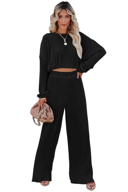 Experience the sleek curves of this Ribbed Design Cropped Corded Pullover and wide-leg pants Set! Crafted from rich 100% Polyester, the pants boast a high waist to flatter your figure. Uncover the perfect look in classic Black!