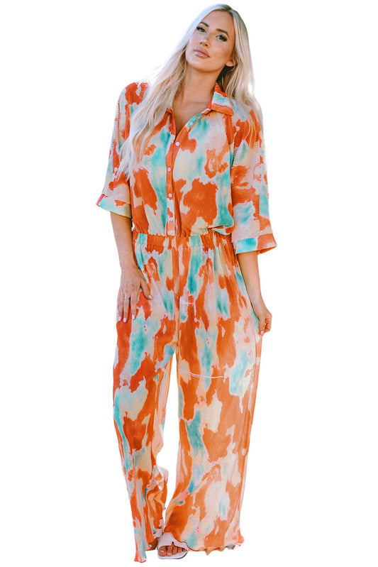 Satiate your cravings for an artsy, Bohemian style with this exquisite tie-dye jumpsuit! With pleated details and a smart shirt collar, short sleeves, and wide-legged bottoms, you'll be the star of any show. Button up and style with whatever shoes you desire, as this versatile one-piece is a hit for any occasion. 100% polyester, of course!