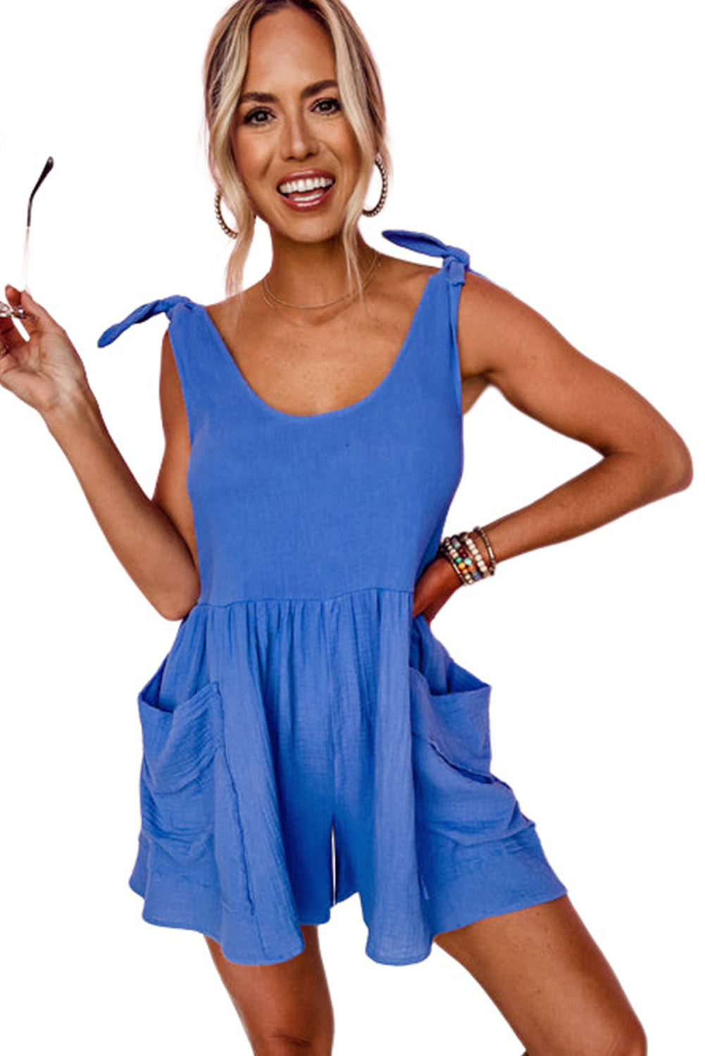 This romper is luxe and lightweight—ideal for sunny-day adventures! Featuring a scoop neck and back, plus raw seam details on the side pockets, you can look as good as you feel. Cinch it up with the adjustable tie straps and channel those playful, breezy vibes. Just add sandals and a statement necklace and you're summer-ready in style. Cotton fabric.