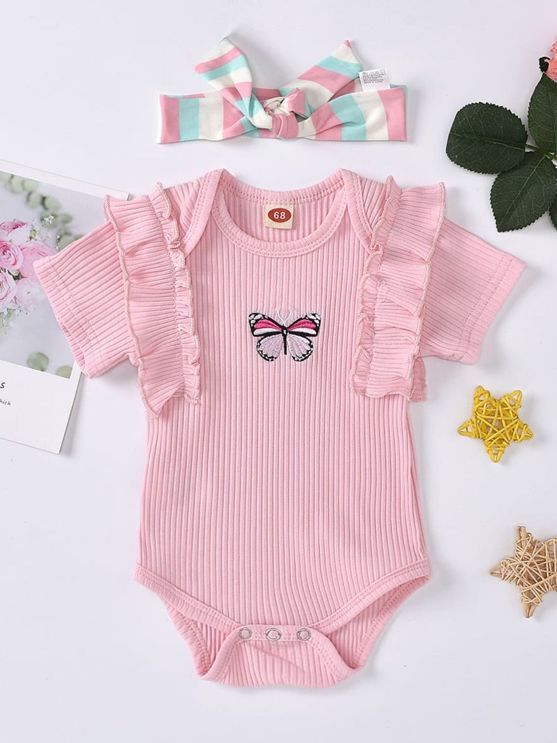 This Butterfly Ruffled Onesie is a playful, ultra-chic must-have! It's crafted with a comfortable 95% cotton and 5% polyester blend, perfect for any sweet baby. The adorable ruffle features a beautiful graphic design, elevating the look from cute to ultra-cute! Short sleeves complete the adorable style. Headband included!