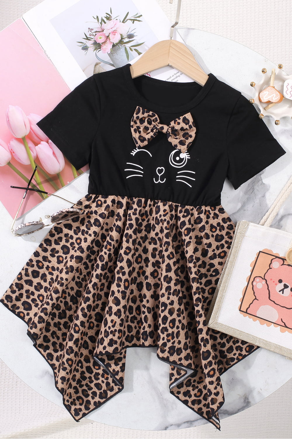 This Fall, your tiny tot can be the chicest cub on the scene in this leopard print dress with short sleeves. Made of 65% polyester, 30% cotton, and 5% spandex for a slight stretch, the look is rounded out with a flouncy ruffle hem. Girl and toddler sizes available!