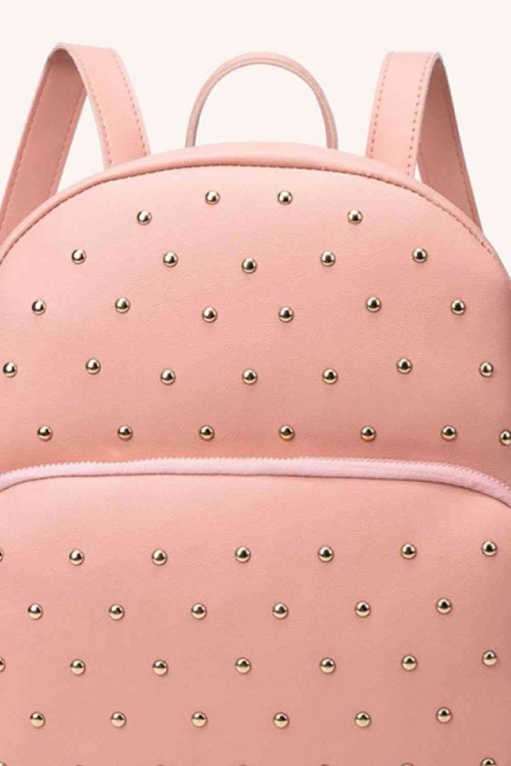 Introducing a stylish, uniquely studded backpack - perfect for everyday use! With both a striking peach and classic black option, this medium-sized bag is crafted with high-quality PU leather and is designed with measurements of 9.5*4.3*11.4 IN so that your belongings fit comfortably. Make a statement and experience the convenience of this fashionable piece!