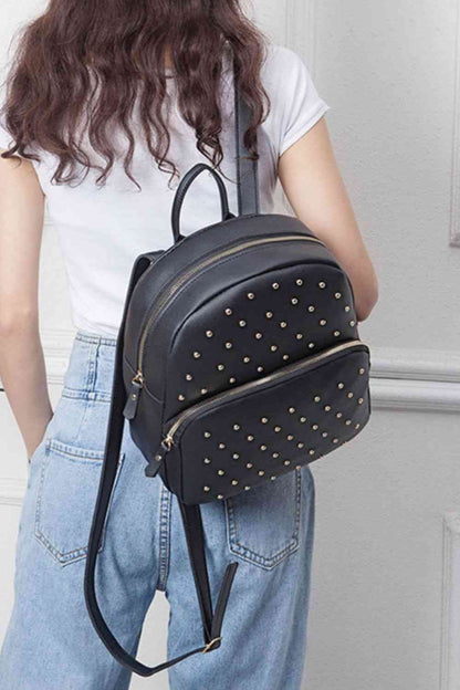 Introducing a stylish, uniquely studded backpack - perfect for everyday use! With both a striking peach and classic black option, this medium-sized bag is crafted with high-quality PU leather and is designed with measurements of 9.5*4.3*11.4 IN so that your belongings fit comfortably. Make a statement and experience the convenience of this fashionable piece!