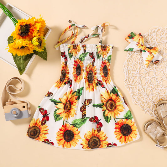 Graceful and chic, your little one will look absolutely darling in this Sunflower Print Smocked Tie Shoulder Dress. Accompanied by a headband to match, the floral pattern is a perfect play of casual and elegance, with a straight neckline and spaghetti straps providing an extra touch of style. Crafted with a blend of 95% polyester and 5% spandex, this dress is sure to be a hit!